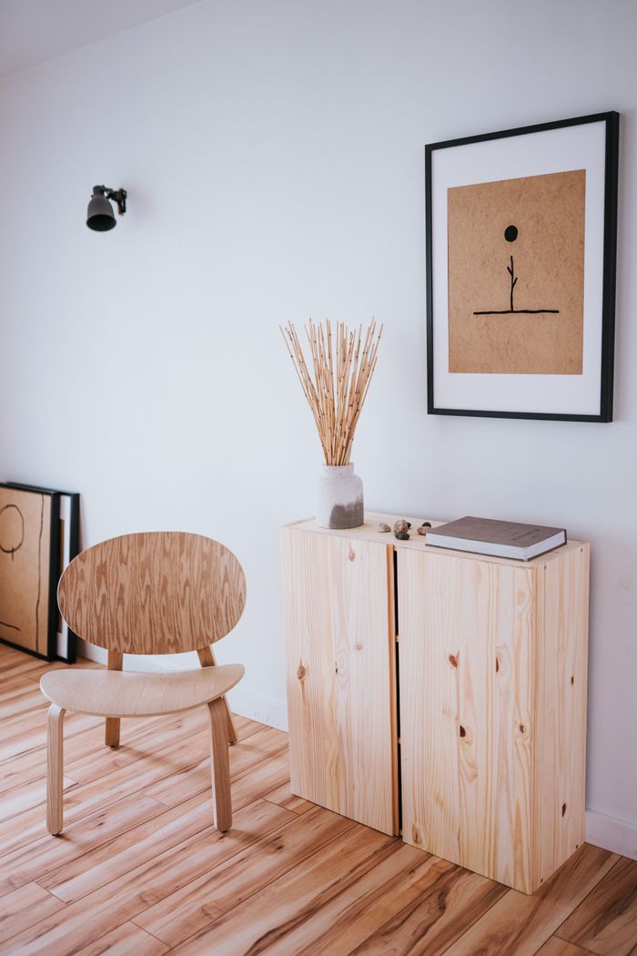 mobile-01 A peaceful Japandi-inspired room showcases wooden furnishings and minimalist artwork, forming a calm, uncluttered setting.